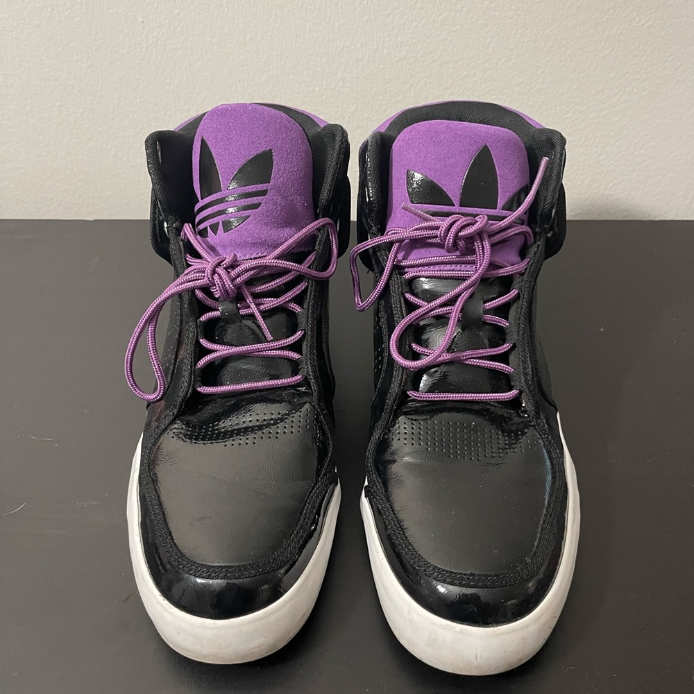 I’m selling some black and purple high top Adidas size 10